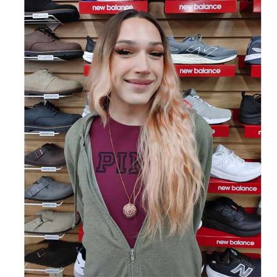 Hunter standing in front of a display of New Balance shoes