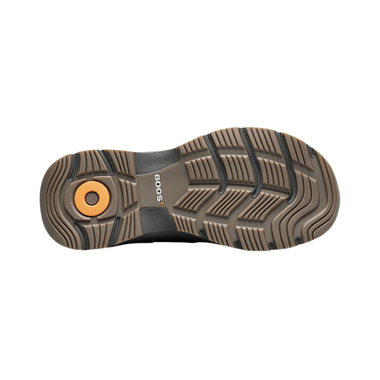 Brown and black boot outsole with deep tread and an orange circular heel insert