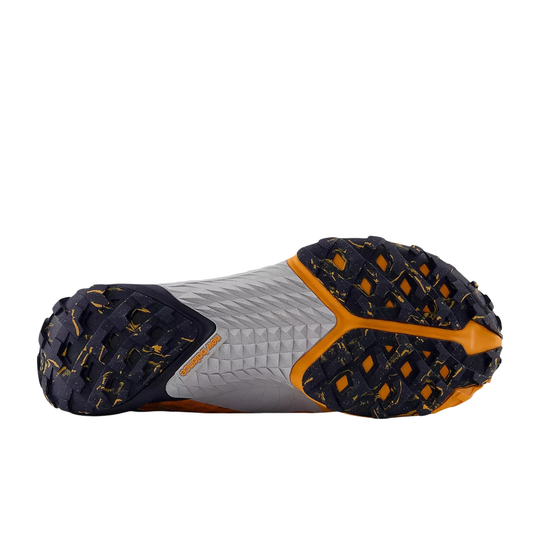 Trail shoe outsole with black lugged tread, gray midsole, and orange accents