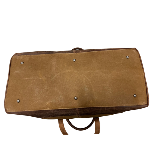 Brown leather bag with metal studs on a white background