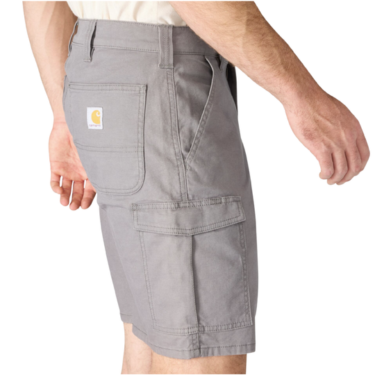 A person wearing light gray cargo shorts, a light-colored t-shirt, black socks, and black boots, shown from the waist down on a white studio background.