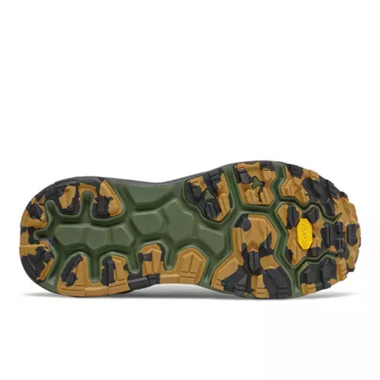 Trail shoe outsole with green, tan, and black camouflage tread