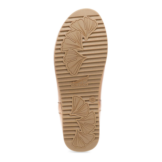 Tan shoe outsole with ginkgo leaf tread pattern and embossed Dansko logo
