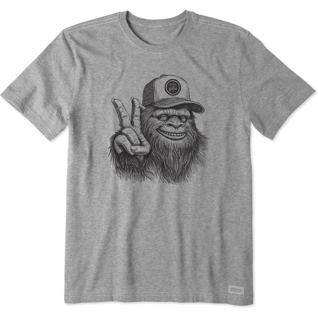 Gray t-shirt with a graphic of a monkey wearing a cap and making a peace sign on a white background.