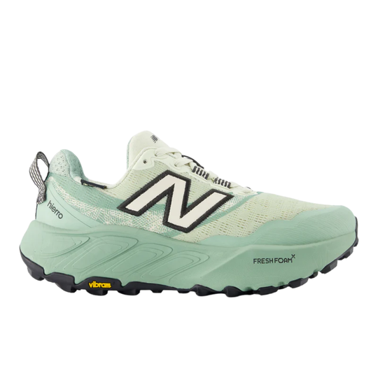 Mint green trail running shoe with black New Balance logo and Vibram outsole