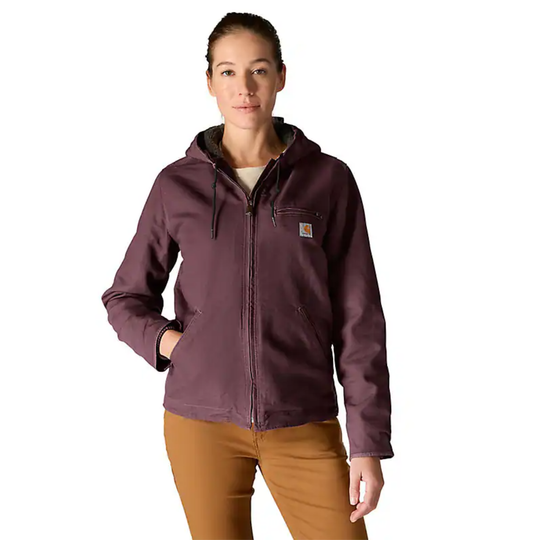 Woman wearing a purple jacket with a visible brand logo on a white background