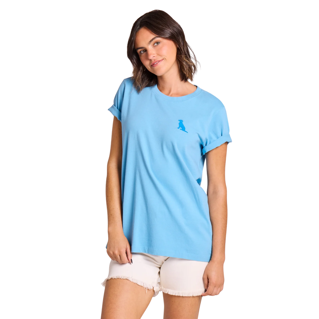 Woman wearing a light blue t-shirt with a small logo on a white background