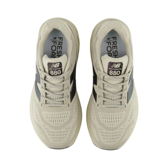 Pair of beige running shoes with mesh uppers, laces, and 'Fresh Foam' and '880' text on the tongues