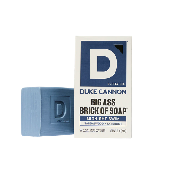 Blue rectangular bar of soap beside its box on a white background.