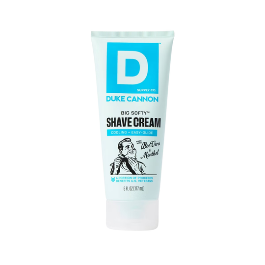 White and light blue tube of shave cream with a large D logo and black illustration near the bottom.