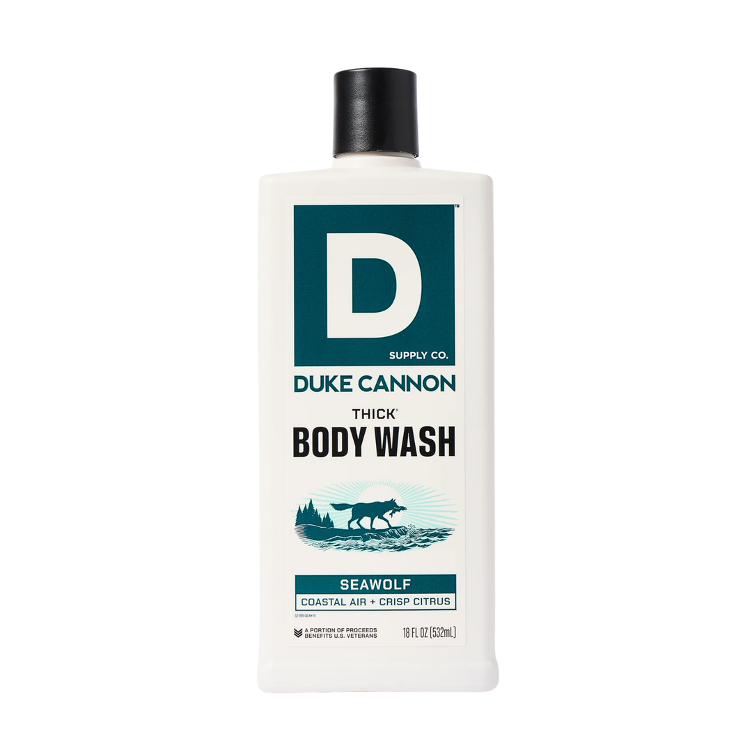 White bottle of body wash with a black cap and teal label on a white background