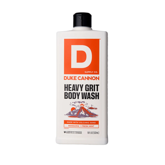 White bottle of heavy grit body wash with an orange label and black cap