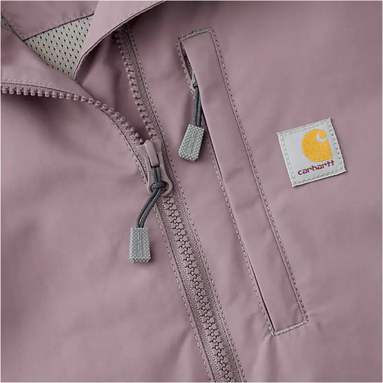 Close-up of a dusty pink zip-front coat with a Carhartt logo patch and chest pocket