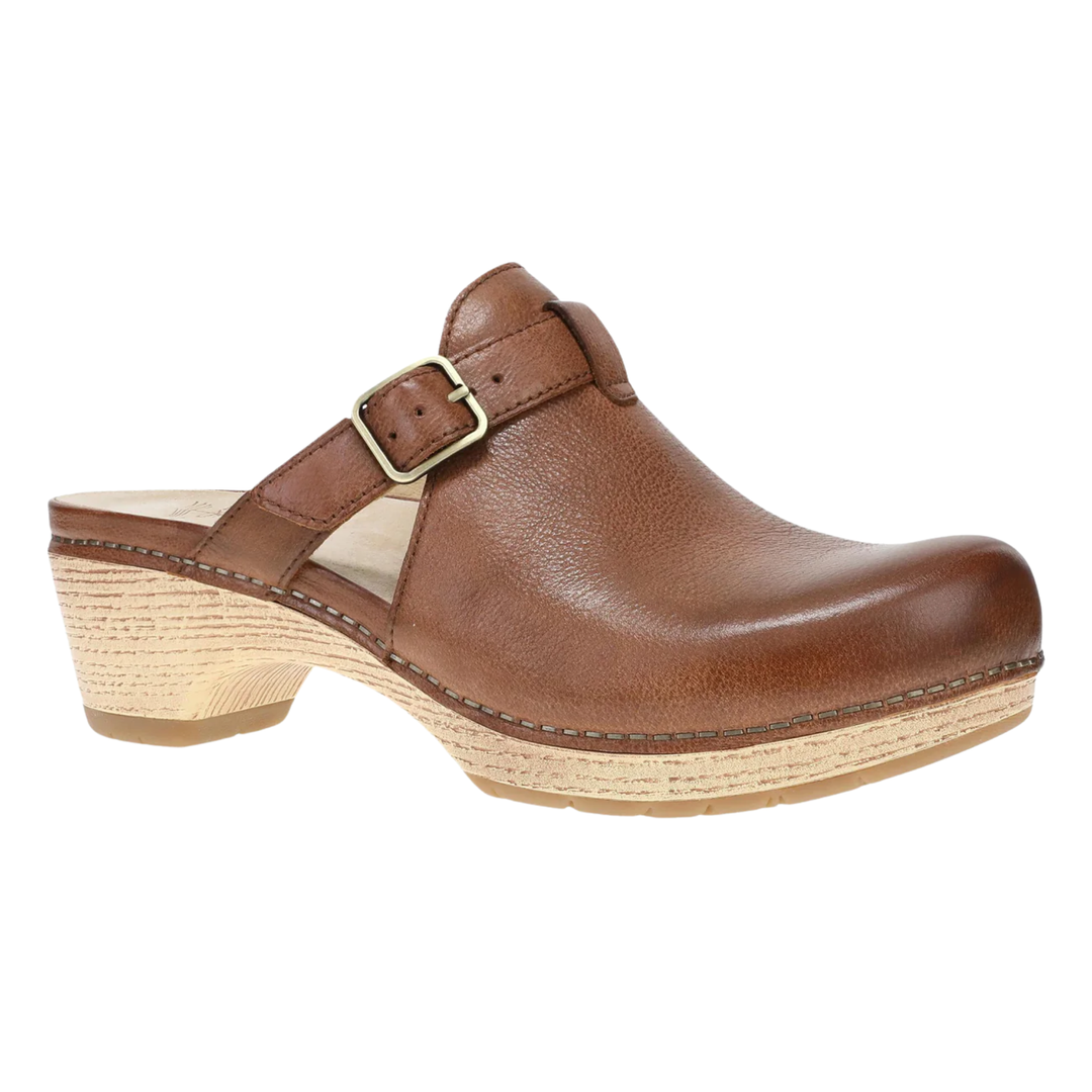 Brown leather clog shoe with a strap on a white background