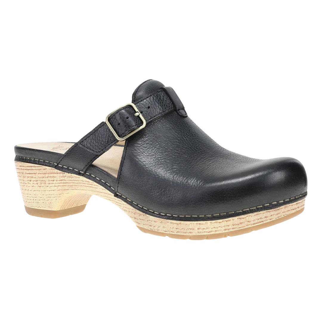 Black leather clog shoe with a strap on a white background