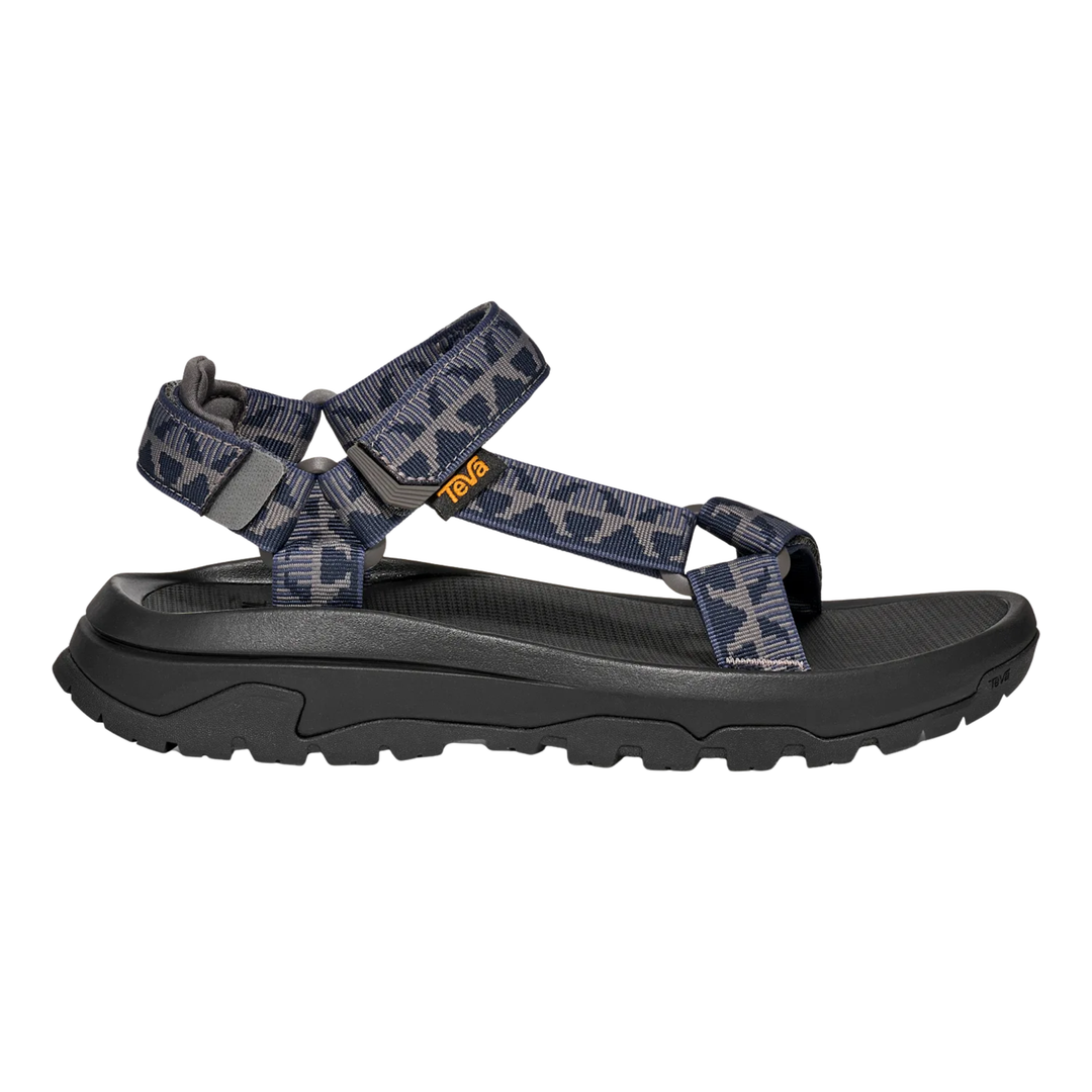 Black sandal with patterned straps on a white background