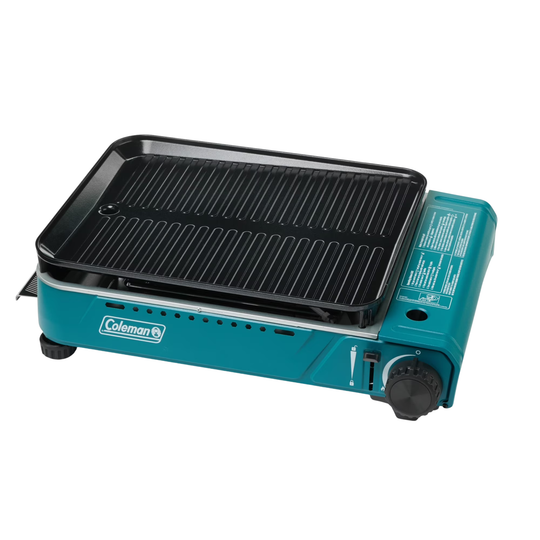 Portable teal tabletop grill with a black griddle top and Coleman logo