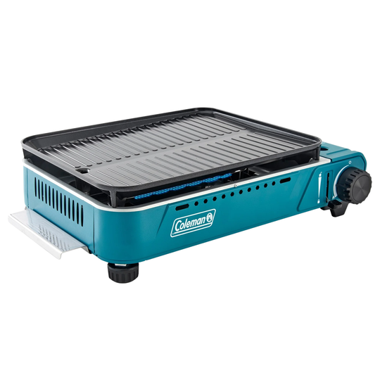 Portable blue tabletop gas grill with a black griddle plate and side control knob