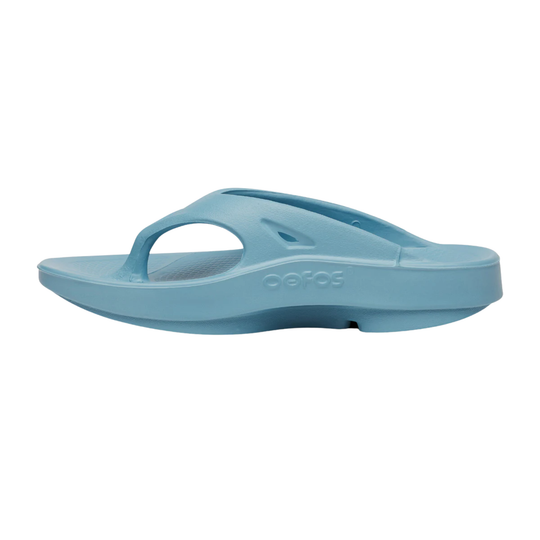 Light blue slip-on sandal with an open toe and embossed Oofos logo on the side