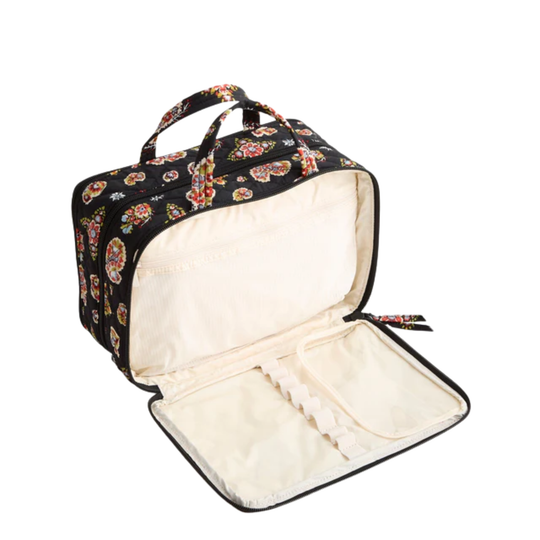 Floral-patterned zippered travel case opened flat with cream interior and handle straps