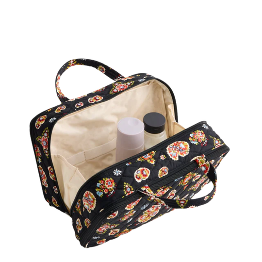 Black quilted floral travel toiletry case with a zip-around opening, top handle, and beige interior pockets