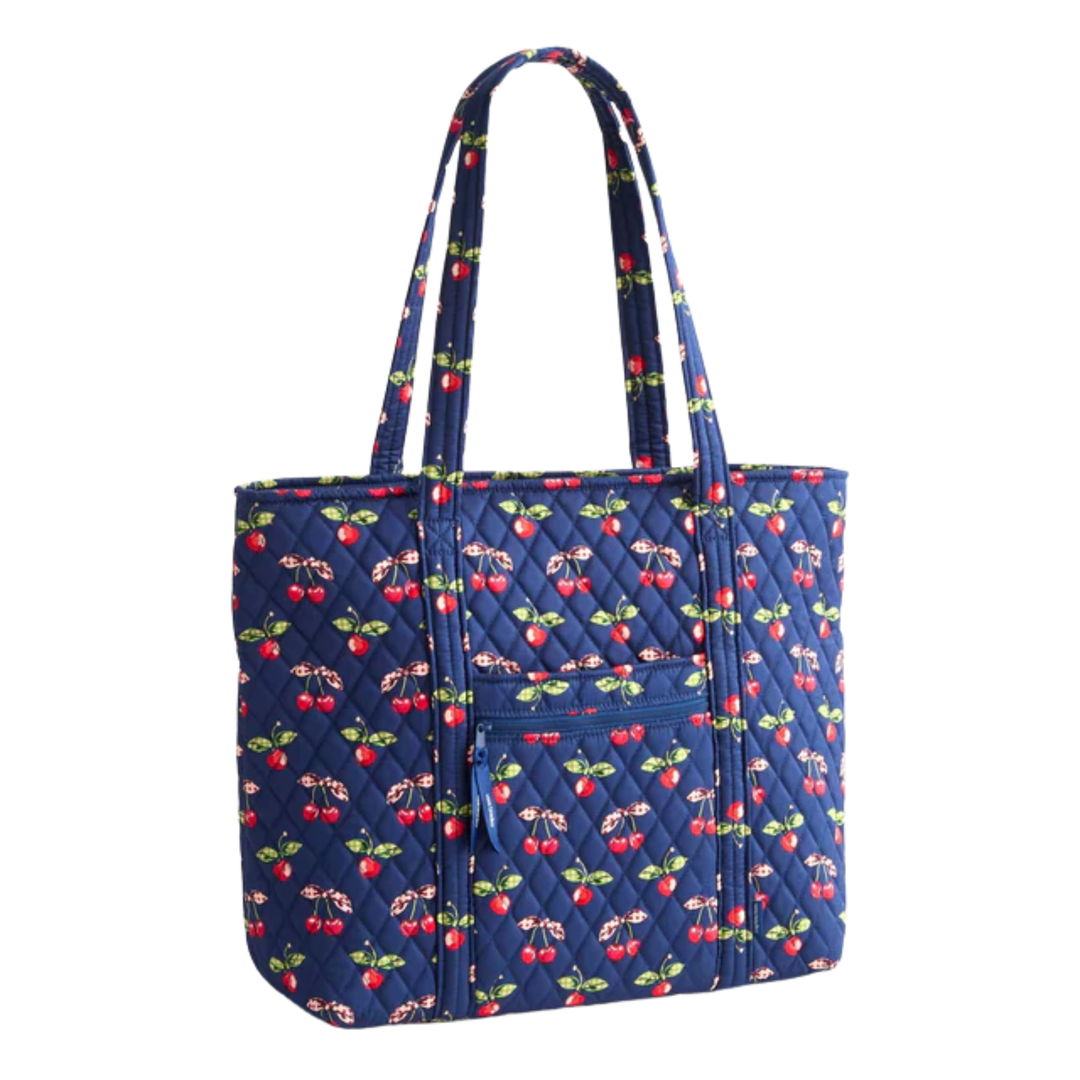 Blue quilted bag with cherry pattern on a white background