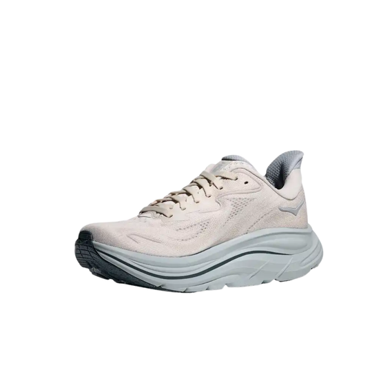 Light beige running shoe with thick white cushioned sole and dark outsole on a white background