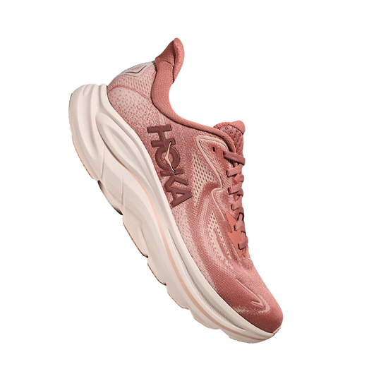 Pink running shoe with thick white sole and visible HOKA logo on the side