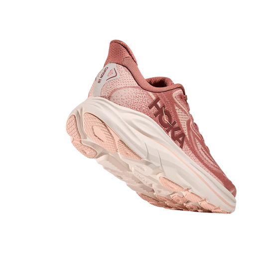 Pink-and-cream running shoe with thick cushioned sole, shown in side view.