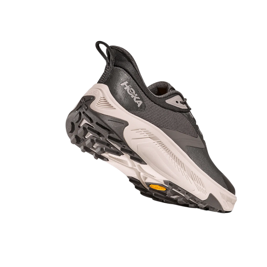 Grey and black hiking shoe with chunky tread and a white midsole, shown from the side and bottom