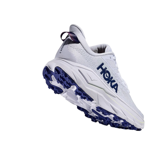 White trail running shoe with navy outsole lugs, side HOKA logo, and heel pull tab