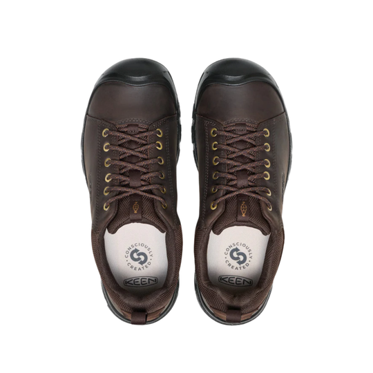 Pair of brown low-top hiking shoes with black toe caps, gold eyelets, and brown laces
