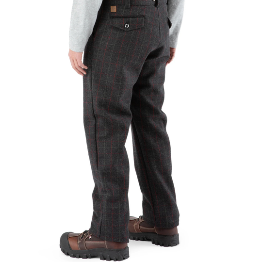 Dark brown tweed pants worn by a person on a white background