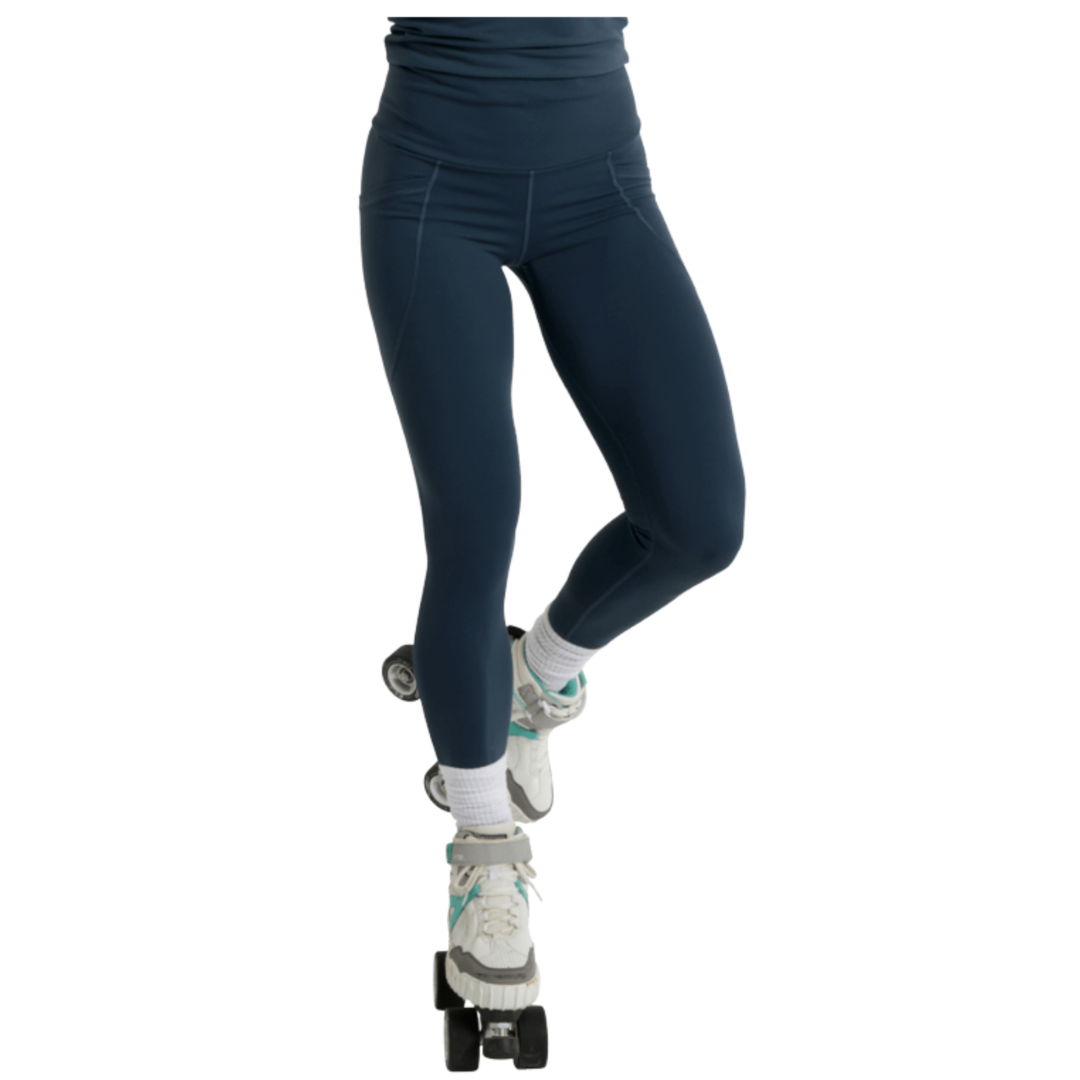 Navy leggings worn with roller skates on a white background