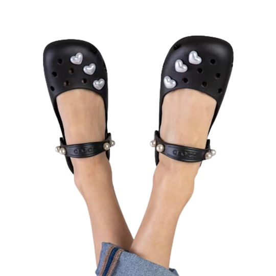 Black sandals with heart designs on a white background
