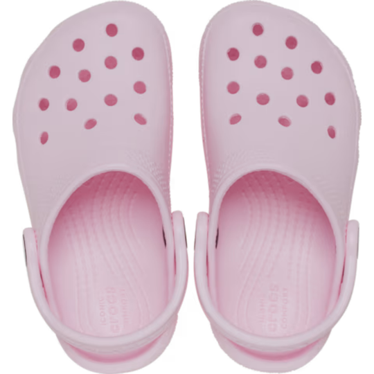 Pair of pink clogs with small holes on a white background