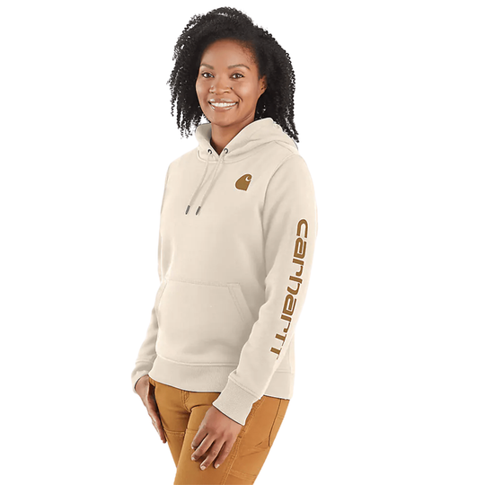 Cream hooded sweatshirt with brown sleeve logo and chest emblem, worn by a model. On a plain white background.