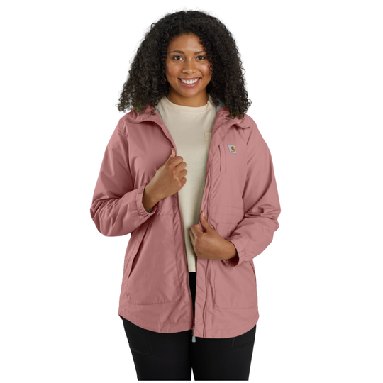 A woman viewed from the front wearing a dusty rose hooded jacket and black pants against a plain white background.