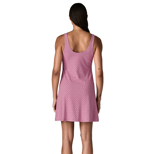 Woman wearing a pink patterned dress on a white background