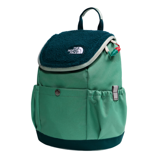 A green and dark teal backpack by The North Face, featuring a plush fleece flap with the brand logo, a front pocket, and side mesh pockets, shown on a plain white background.