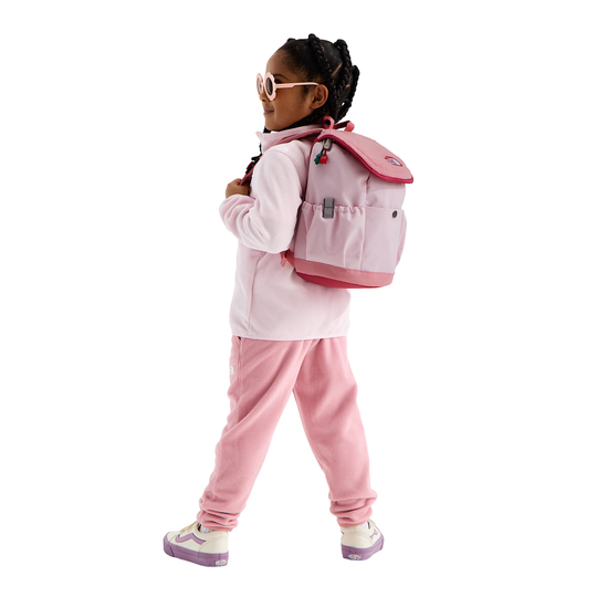 A young girl wearing a pink and white outfit, pink pants, and a pink backpack, shown from the back against a solid white background.