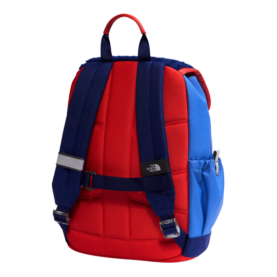 A red and blue backpack shown from the back, featuring navy blue padded shoulder straps, a top carry handle, a side mesh pocket, and a small black The North Face logo patch.