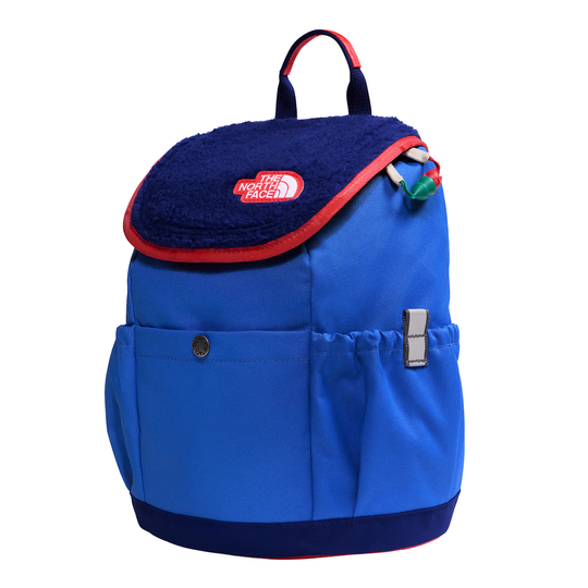 A blue and navy backpack with a plush navy blue flap, red trim, and a visible The North Face logo patch on the front, shown on a plain white background.