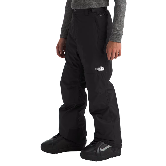 Person wearing black snow pants with The North Face logo on a white background