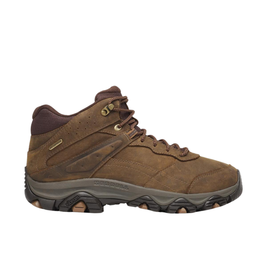A brown suede and synthetic hiking boot shown in a side profile on a plain white background. The boot features a brown laces, a dark brown collar, and a gray midsole with 'Merrell' printed on it.