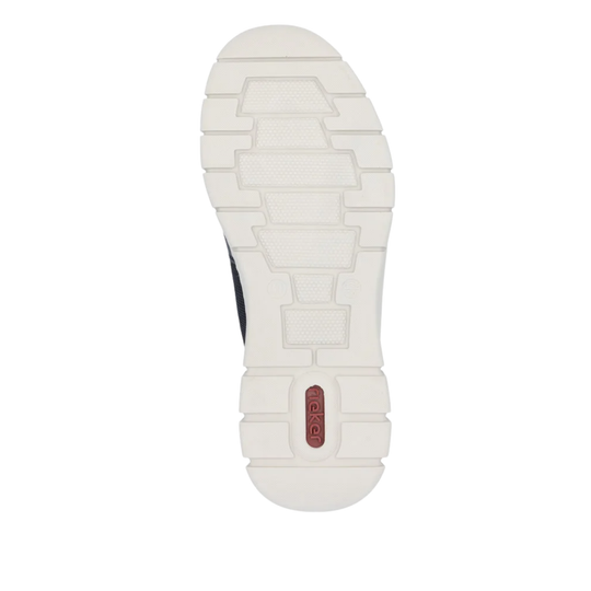 The outsole of a shoe shown from a top-down view, featuring a textured white tread pattern with a small red heel accent containing the brand name 'rieker'.