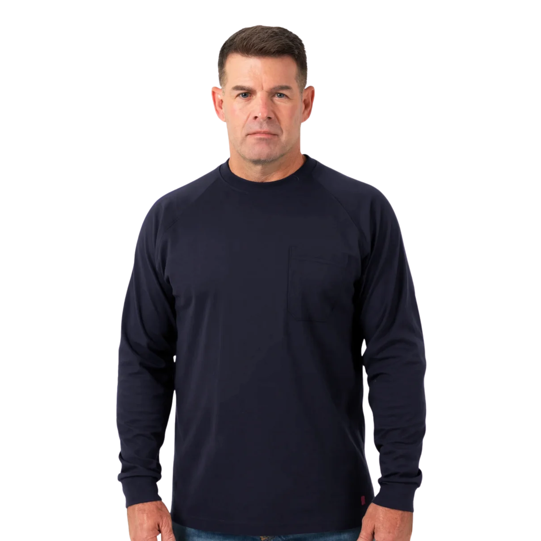 A man wearing a dark navy blue long-sleeve crewneck work shirt with a chest pocket, photographed against a solid white background.