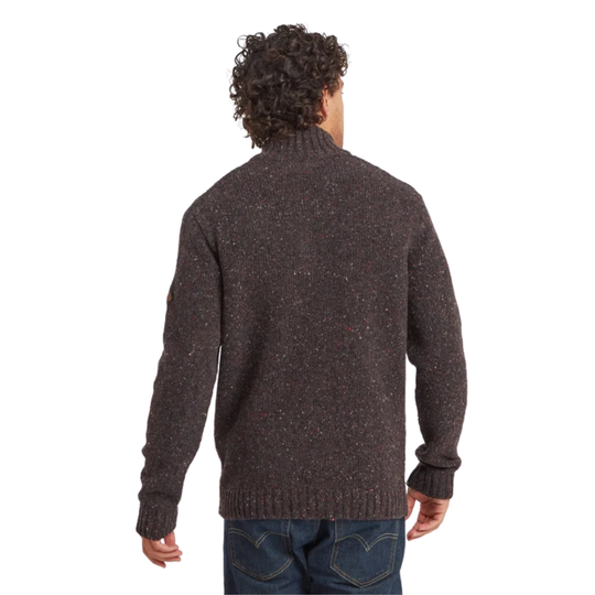 A man viewed from behind wearing a dark brown heathered knit sweater and blue jeans against a plain white background.