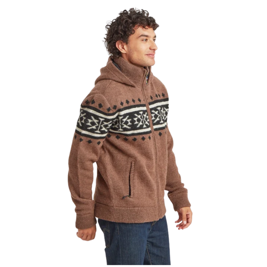 A man wearing a brown knit zip-up hoodie with a black and white Fair Isle pattern across the chest, paired with blue jeans, shown against a plain white background.