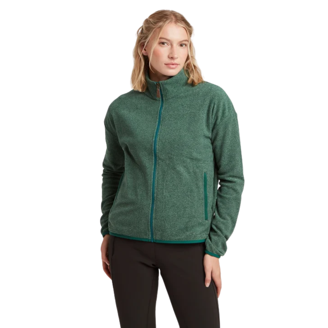 A woman modeling a dark green heathered zip-up fleece jacket with matching green zipper trim, paired with black pants, against a plain white background.